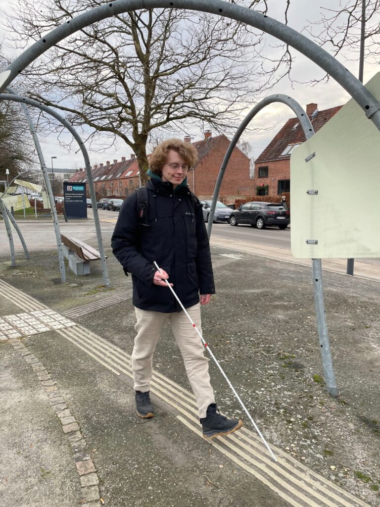 Jonas går på forpladsen med sin markeringsstok. 